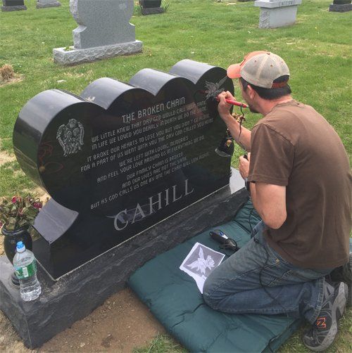 On location lettering work being carried out on a headstone in the cemetery