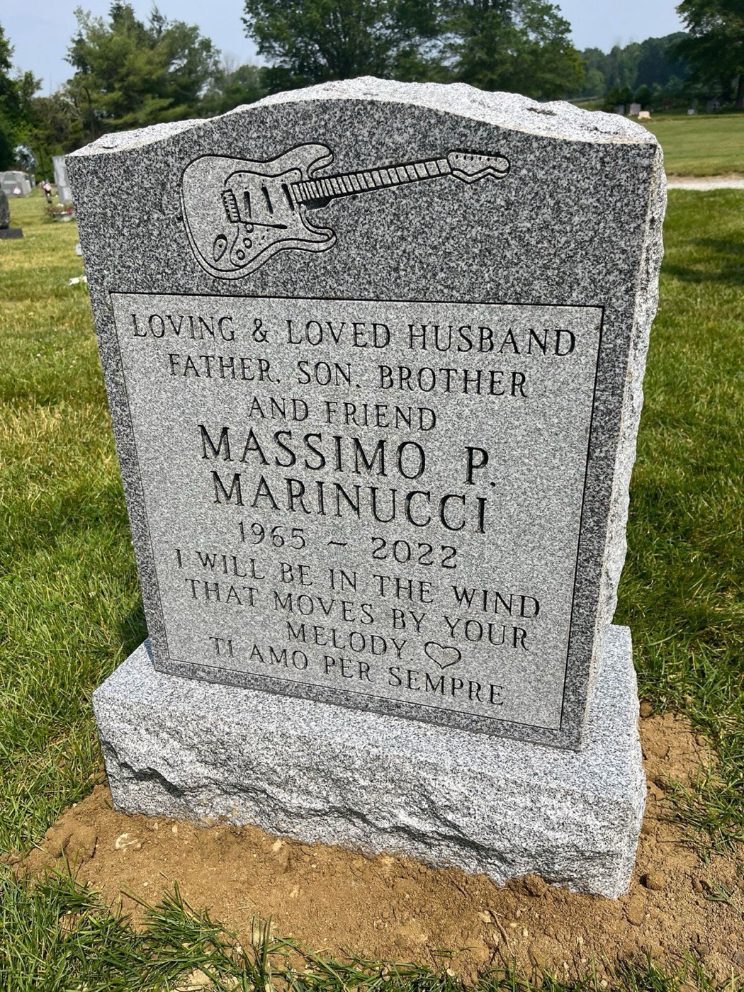 Granite upright monument standing in a cemetery