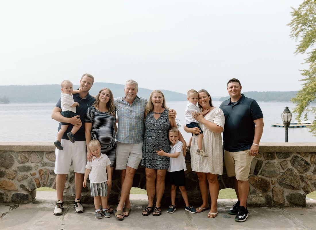 Three generations of the family together on a lakeside terrace